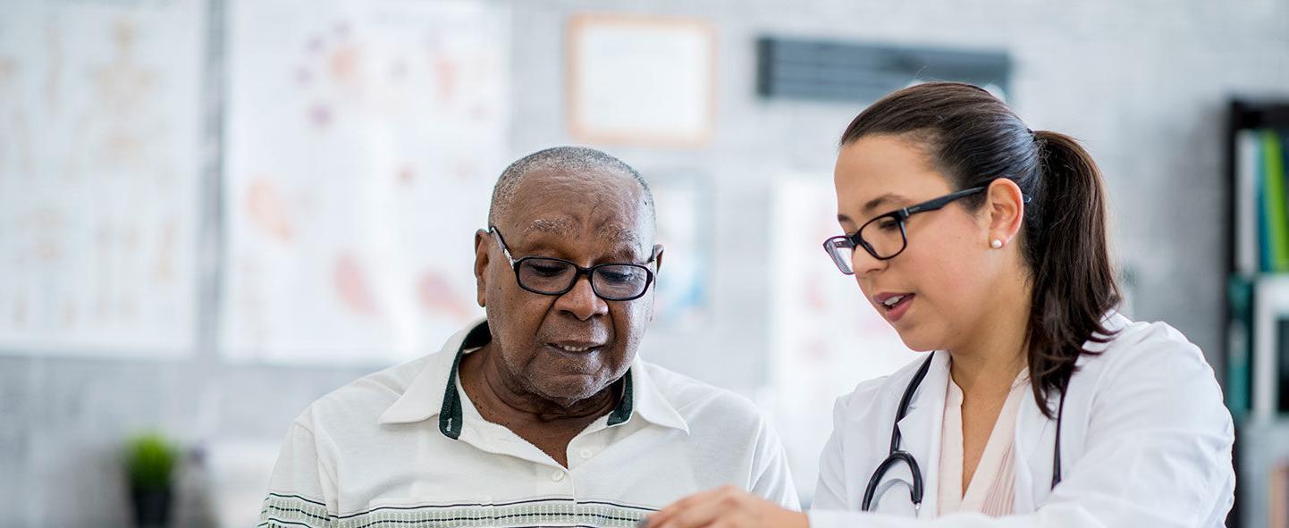 Nurse showing elderly man information on tablet